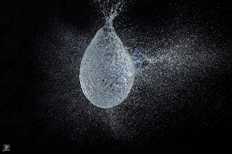 Bursting blue water balloon