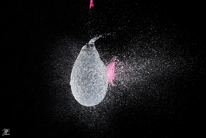 Bursting pink water balloon