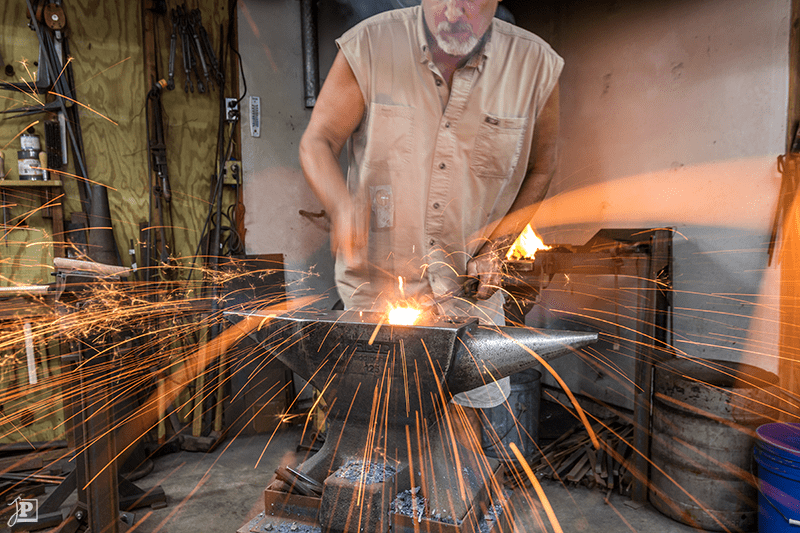 Sparks flying from steel while forge-welding