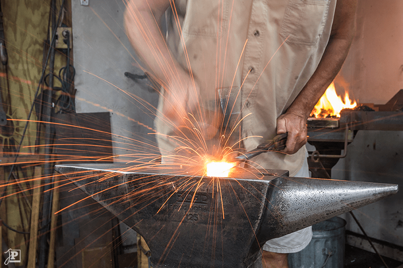 Sparks flying from steel while forge-welding