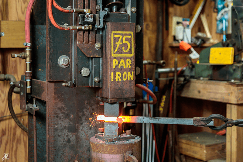 A power hammer hitting steel