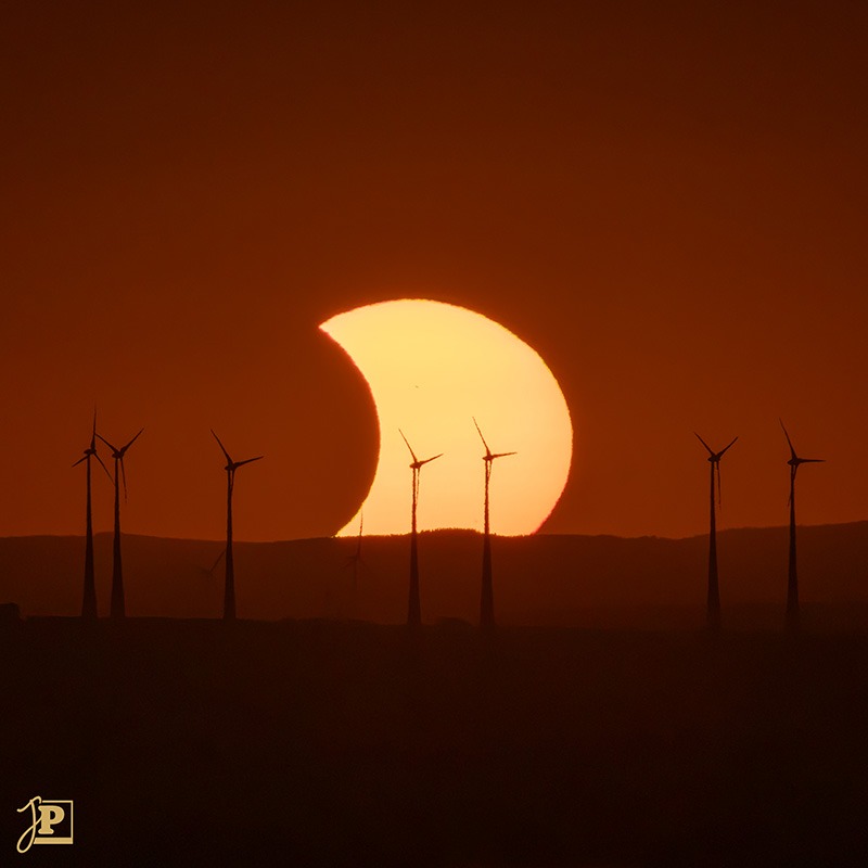 Sunset with silhouetted wind turbines